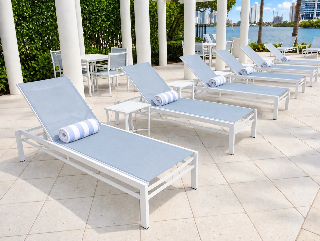 White sling lounges overlooking the waterfront