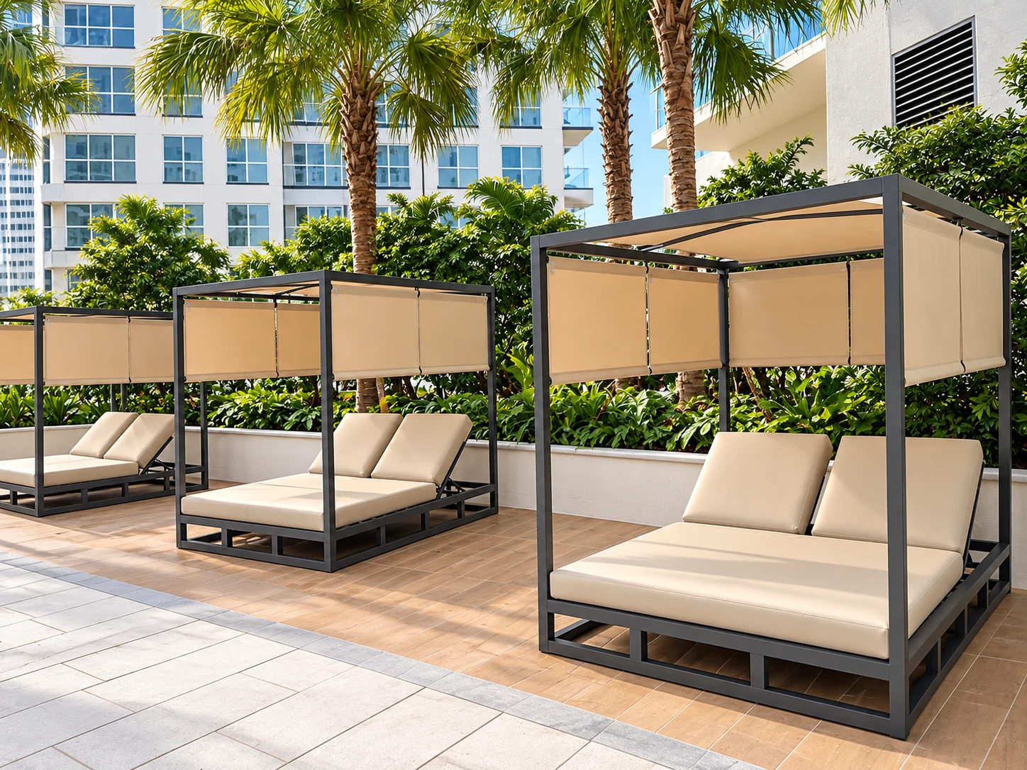 Cushioned cabanas with shade panels beneath palm trees