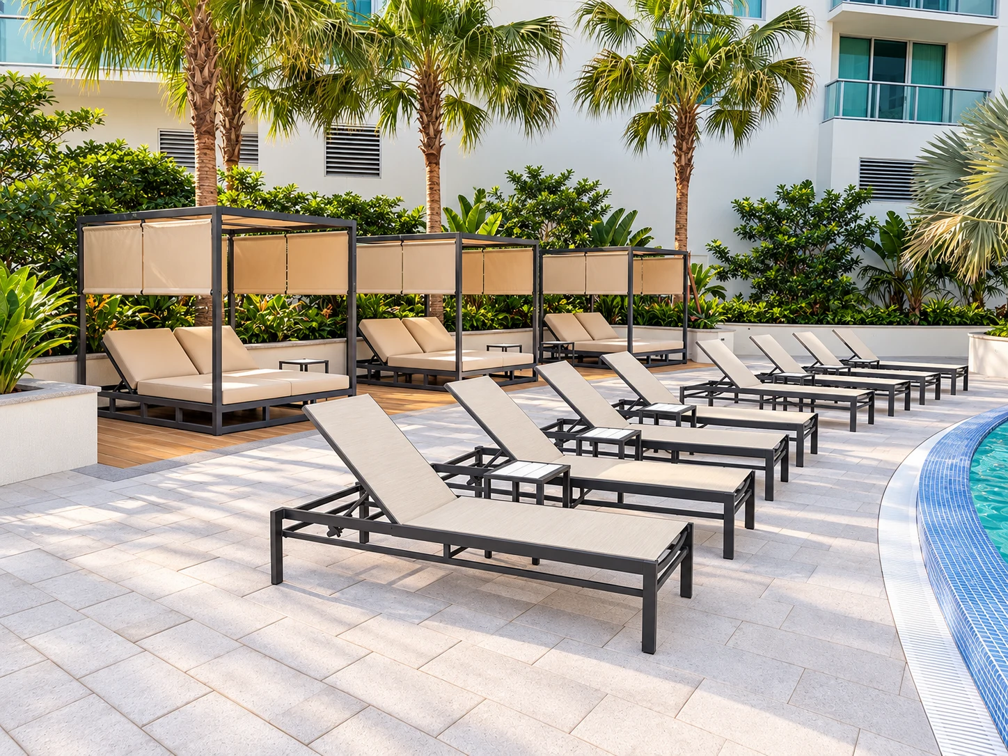 Sun lounges and shaded cabanas beside a tropical pool